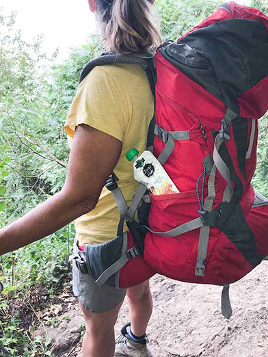 Photo of person hiking with a Maple To Go pouch in their backpack