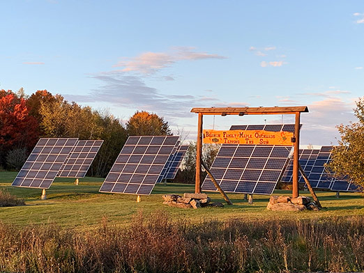 Photo of solar panels and Branon wooden sign