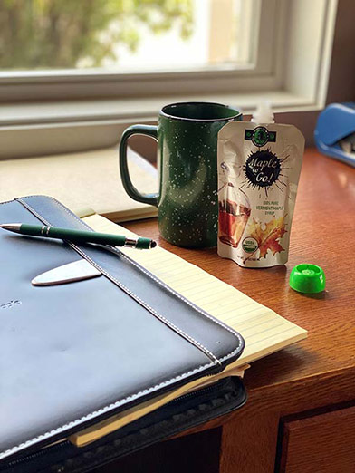 Photo of a Maple To Go pouch with a coffee mug on a desk
