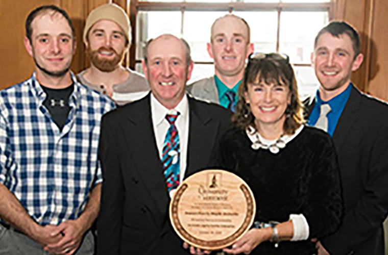 Photo of Branon family holding an award