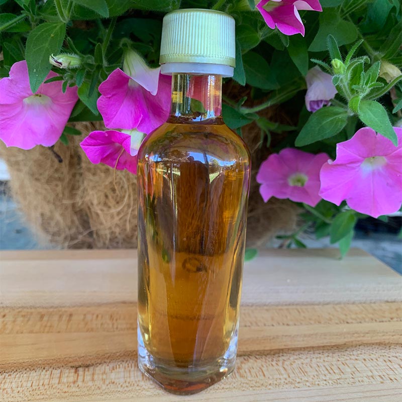 Photo of Bellolio Round favor bottle with pink petunias in background
