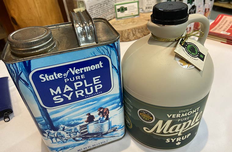 Photo of Maple Syrup in BPA free plastic jug beside syrup in a can